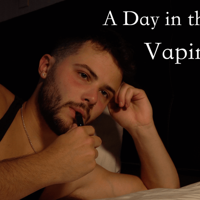 A Day in the life Vaping. A Man in a tank top with his vape up to his lips. 